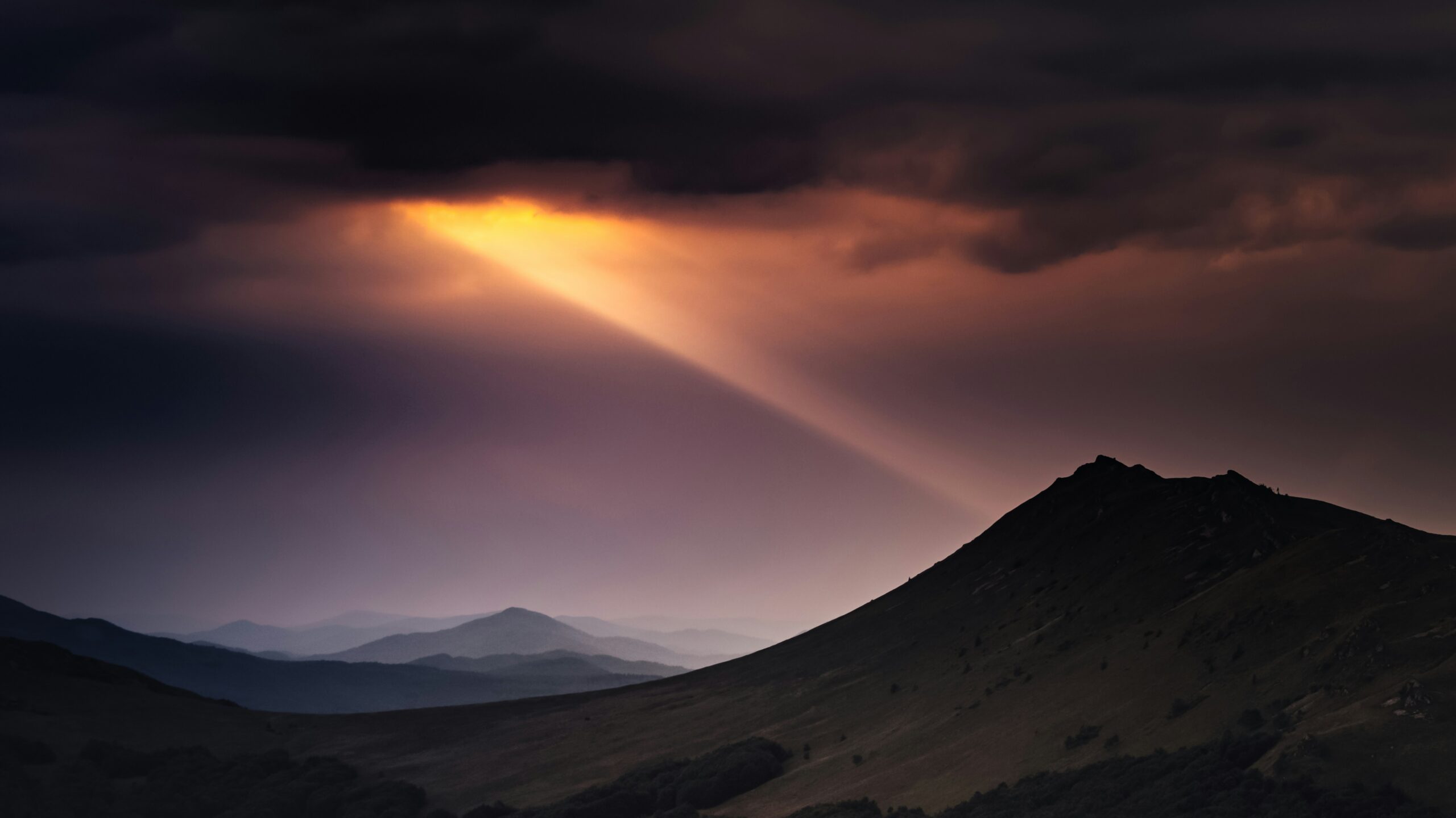 God's light shines down from a dark sky.