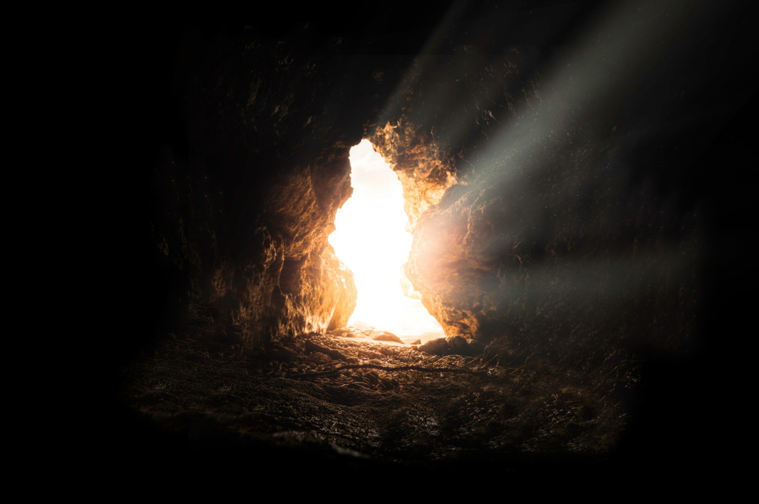 Light enters through the door of a dark cave.