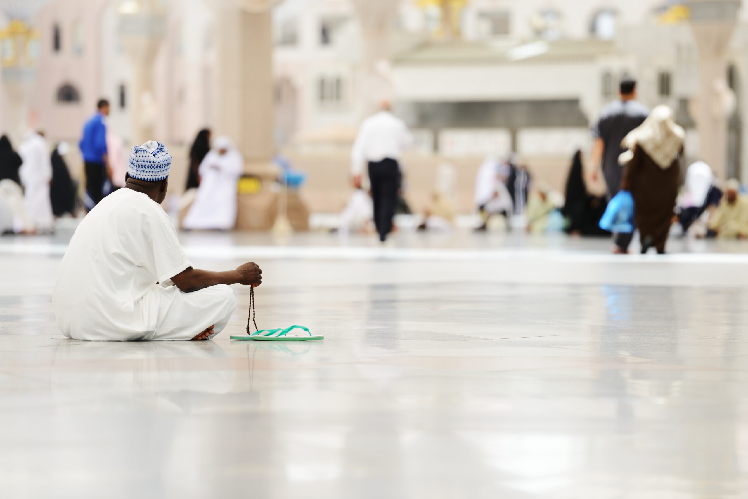 African Muslim sitting on the floor of the mosque during pilgrimage