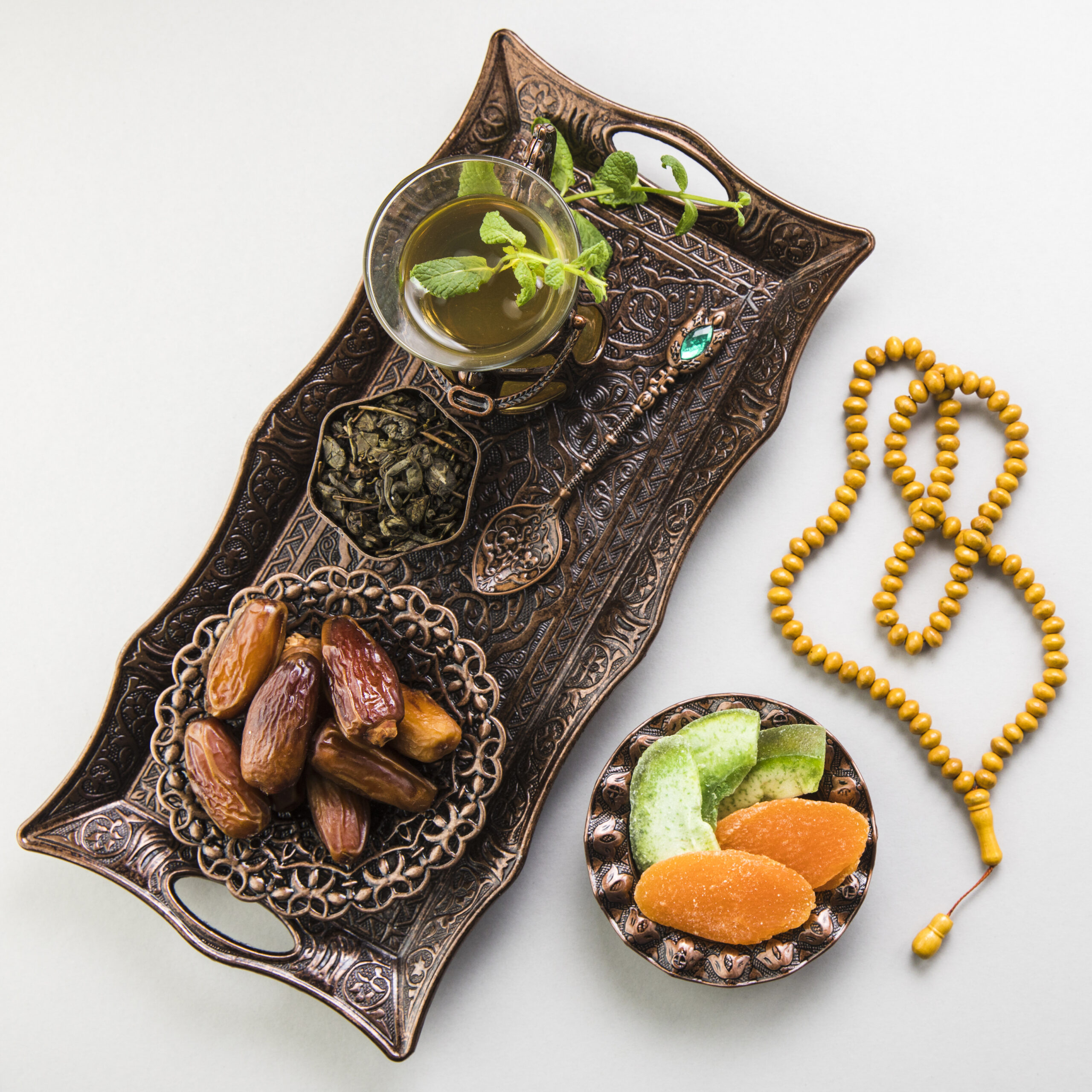 Muslim plate with dates and a cup of tea.