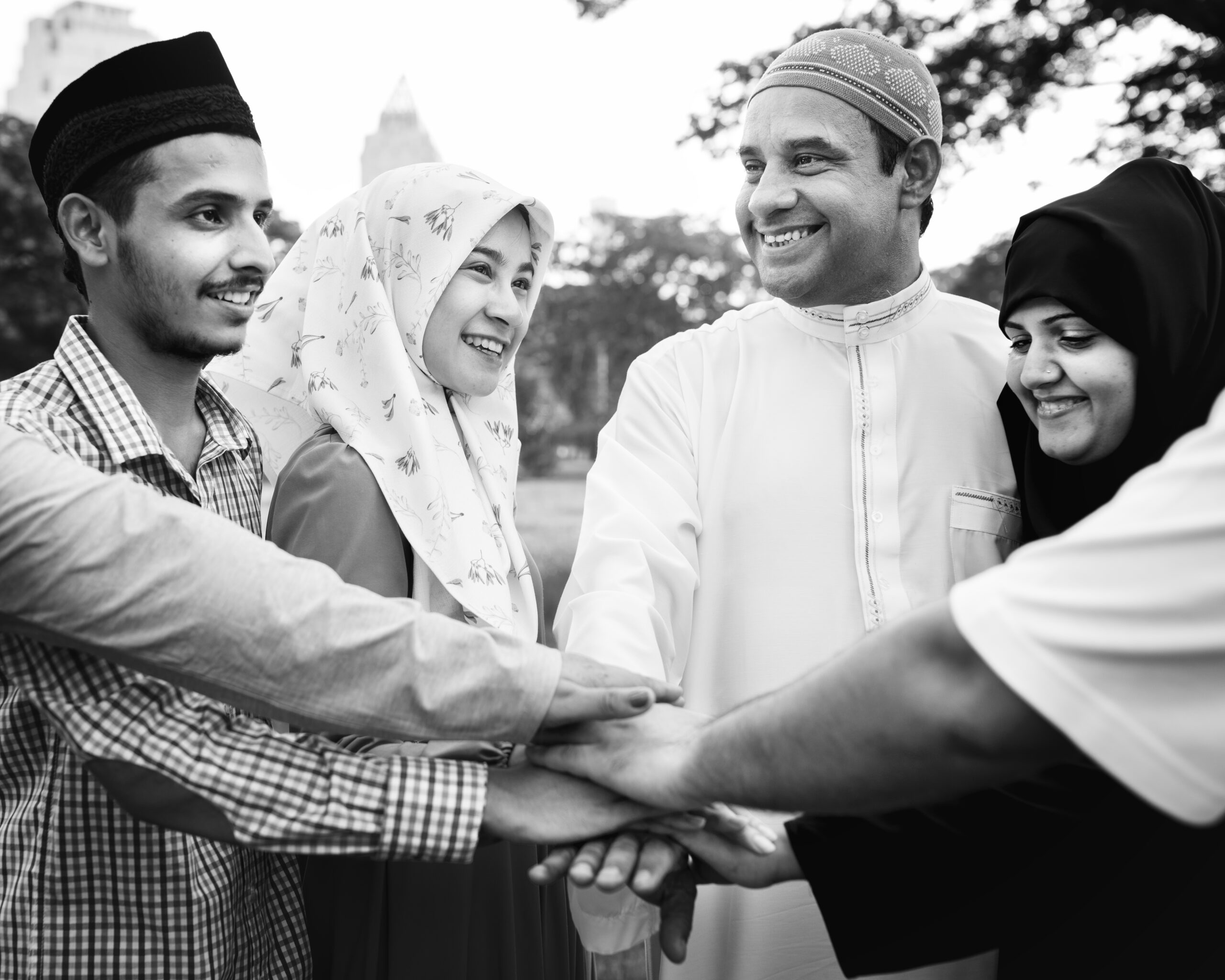 Group Muslims putting their hands together at a charity - zakat gathering.