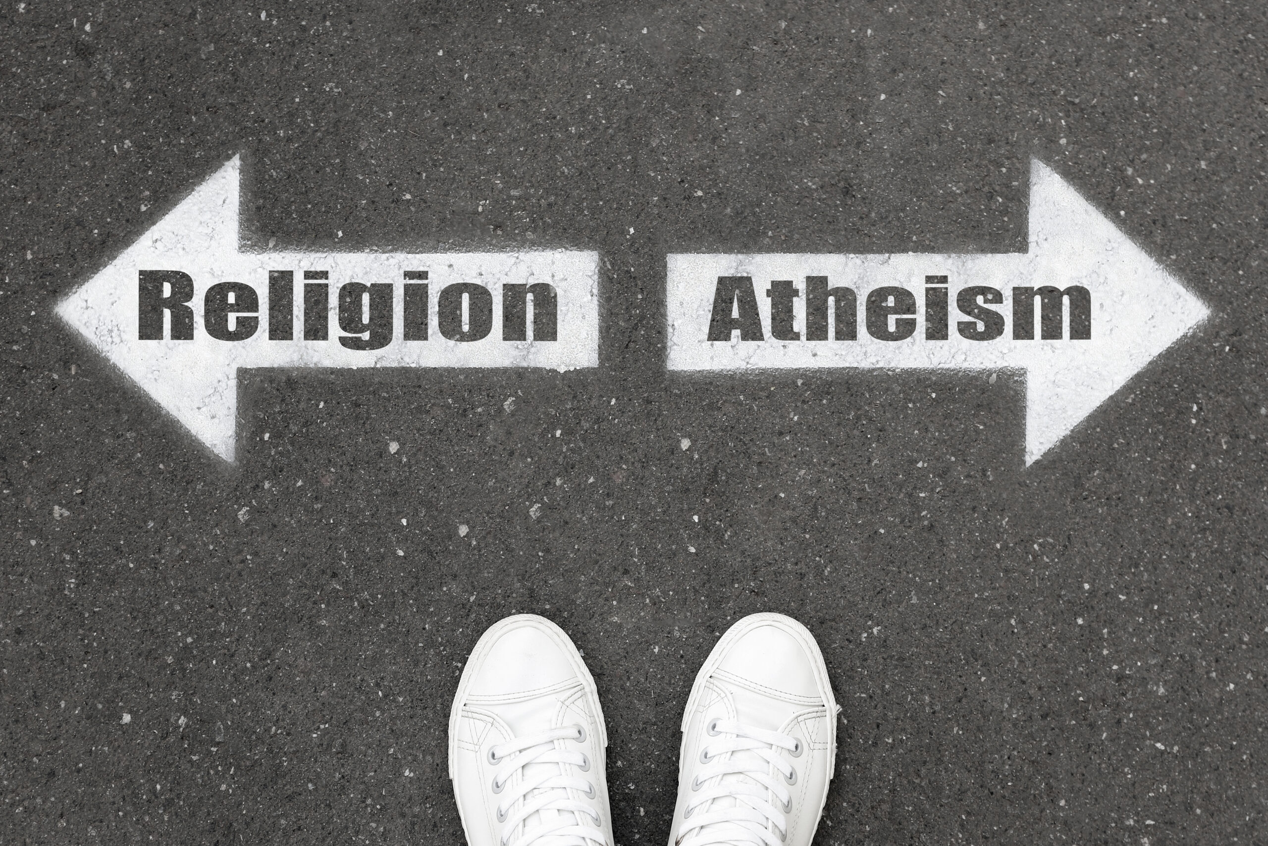 Young man choosing between religion and atheism.