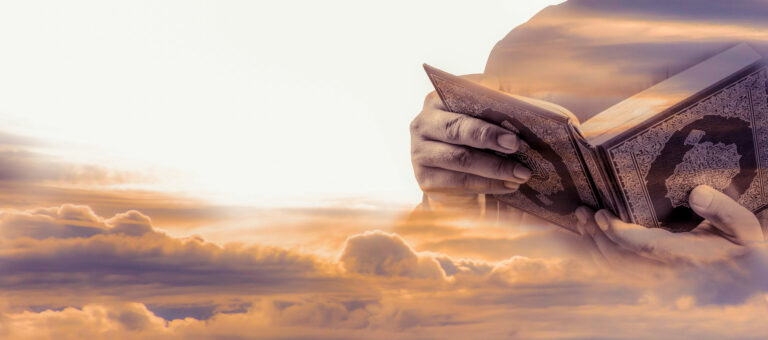 A person's hands hold an open Quran against a backdrop of softly illuminated clouds, symbolizing spirituality and tranquility.