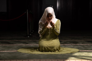 Muslim young woman praying in a private peaceful place