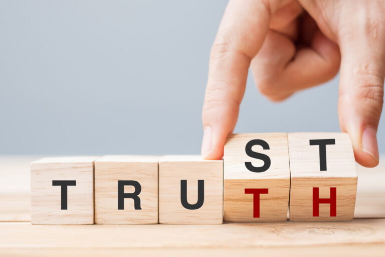 A Muslim turning the word trust ion a cube into the word truth,